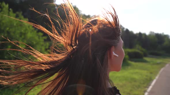 Back View Pretty Sporty Woman Jogging at Park in Sunrise Light alt