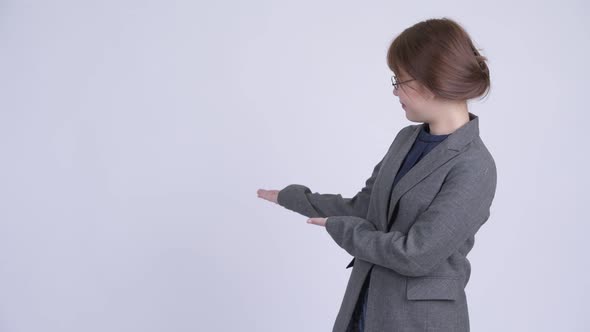 Young Happy Asian Businesswoman Showing Something alt