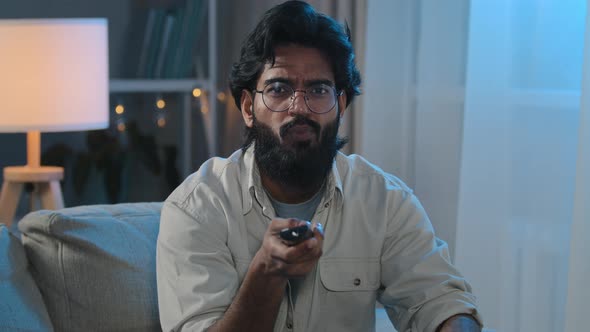 Evening Entertainment Arabian Indian Man Bearded Male in Glasses in Darkness Living at Home Guy Sits alt