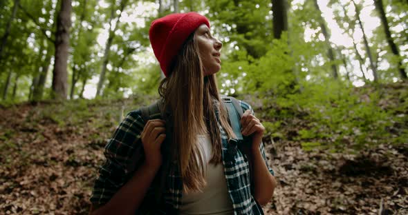 Woman with Backpack in Forest