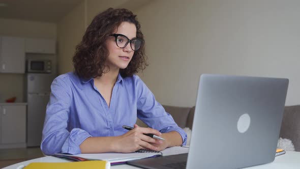 Serious Hispanic Young Woman Freelancer Working Online on Computer Laptop alt