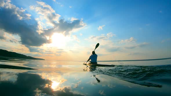Backside View of a Male Paddler While Rowing alt