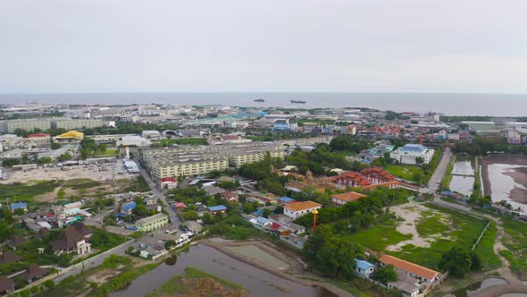 Aerial top view of Samut Prakan urban city, Thailand. Architecture buildings with sea. alt