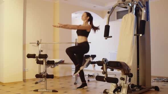 Slim Brunette Caucasian Sportswoman Running in Place with Hands Stretching Forward alt