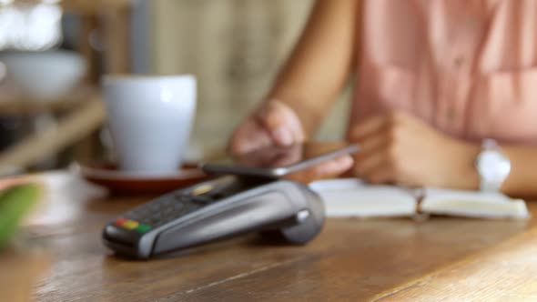 Teenage girl making payment through NFC 4k alt