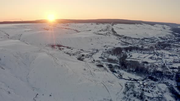 The Sun Peeks Out From Behind the Mountains at Dawn in the Winter