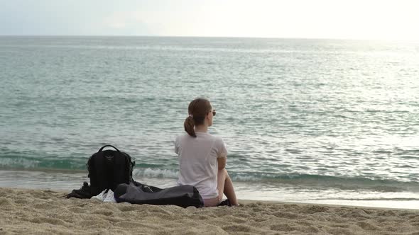 Girl Sitting By the Sea on the Sand in Alanya, Turkey alt