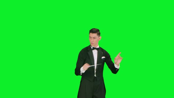 An Orchestra Leader Wearing Suit Using Conducting Baton to Synchronize Musicians alt