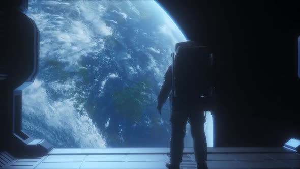 Astronaut Looking To The Earth In Space