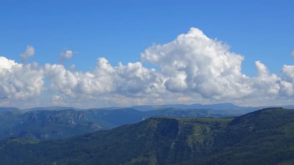 Timelapse in valley with beautiful clouds moving fast in national park of Dombay