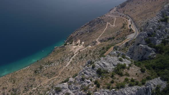 Fantastic Aerial View of a Mountain Road with Incredibly Beautiful Sea in the Background