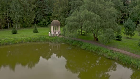 A White Rotunda on the Shore of a Small Pond in the Summer