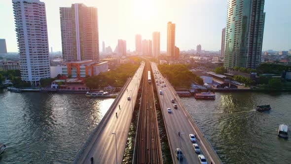 4K : Drones fly over the Chao Phraya River. Aerial view over bts skytrain alt