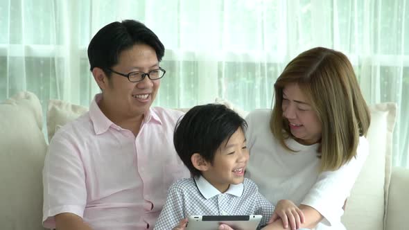Asian Family Using Tablet At Home alt