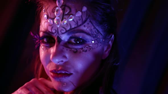 Portrait of a Beautiful Woman with an Unusual Pattern and with Rhinestones on Her Face Posing in alt