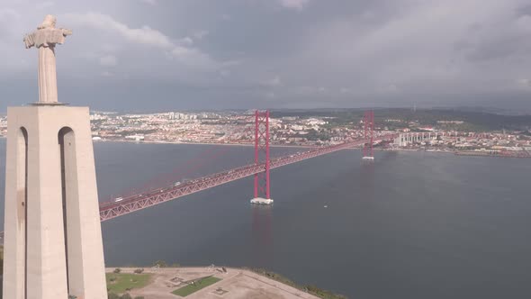 Aerial of Christ the King statue and 25 de Abril Bridge