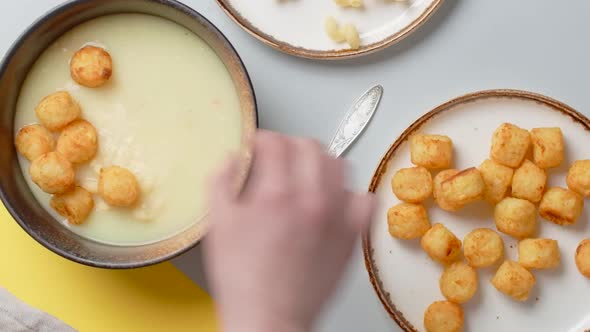 Vertical Flat Lay Food Video the Cook Adds Fried Potato Balls to the Puree Soup