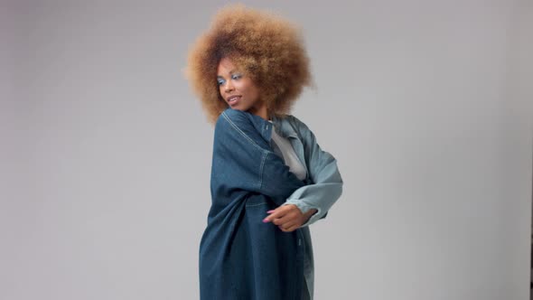 Mixed Race Black Woman with Afro Hair in Studio Alone in Denim Shirt Slow Motion alt