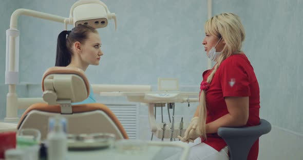 Pretty Female Doctor Talks to the Patient About Further Procedures alt