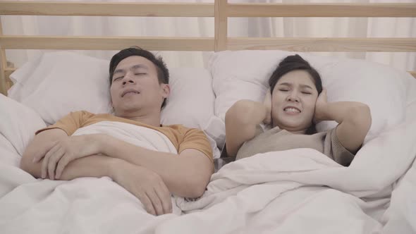 Asian couple wife annoyed Snore's husband when their sleep female insomnia and can't sleep. alt