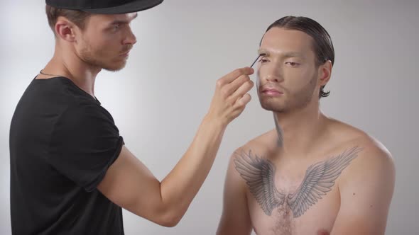 Make-Up Artist Using Spoolie on Male Model alt