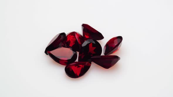 Natural Red Garnet Gemstone on the White Background on the Turning Table