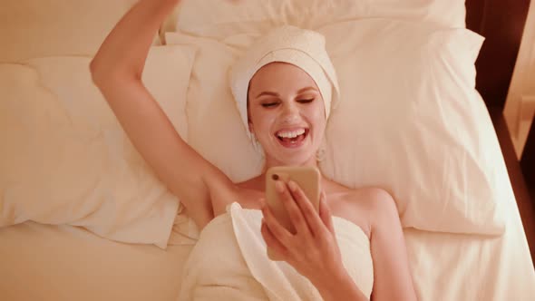 Excited Girl Winner Looking at Mobile Phone Using App alt