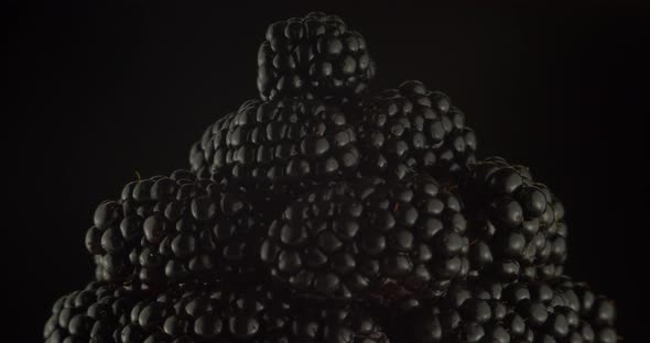 Ripe Blackberries on A Plate Rotate on A Black Background