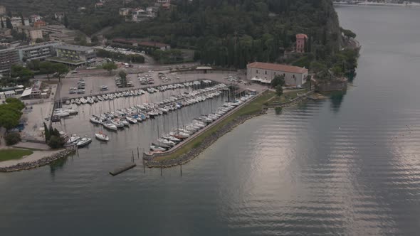 Lago di Garda Harbor in Riva del Garda City, Trentino Italy. Lakefront on Summer Morning, Drone Shot alt