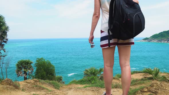 Feet of A Tourist Girl Traveling Through a Tropical Country with A Backpack alt