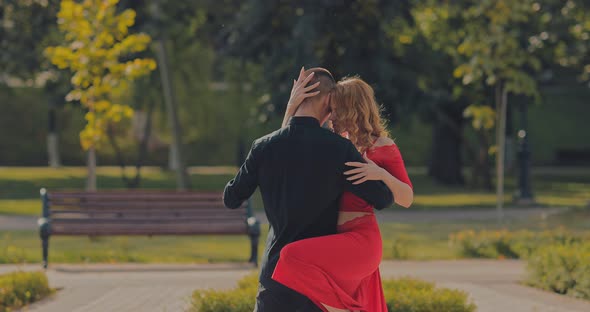 Professional Dancers Dance Tango in the Park Passionate Support and Hand Movements