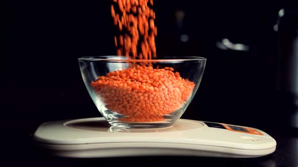 Healthy Lifestyle Food On Owerweight. Loosing Weight Diet And Weighing Red Lentils On Kitchen Scales alt