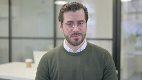 Portrait of Young Businessman Looking at the Camera Sad Expression alt
