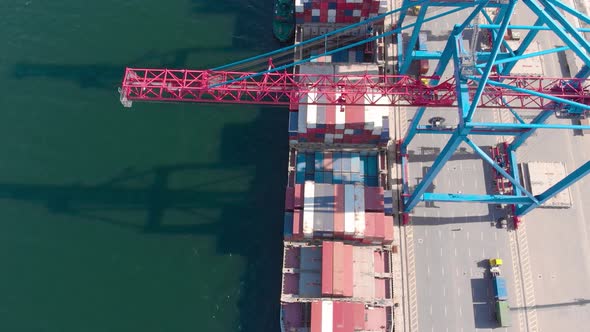 Drone Flying Over a Container Ship During Cargo Operations Over the Customs Area alt
