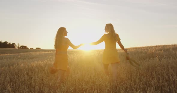Two Blondes are Happy and Laughing at Sunset alt