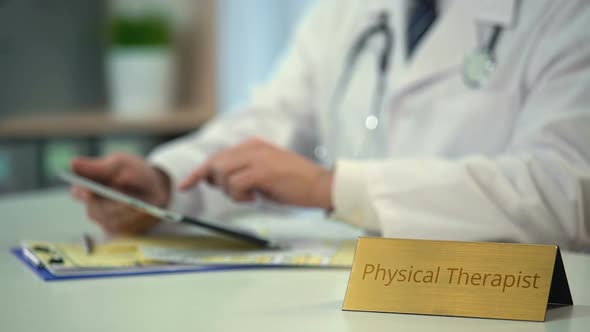 Physical Therapist Viewing X-Ray Images on Tablet PC, Medical Application alt