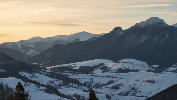 Winter Rural Landscape Under the Mountains at the End of the Day alt
