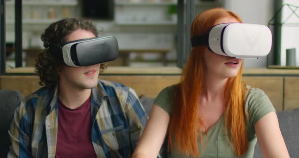 Young Couple Is Trying Virtual Reality Headset alt