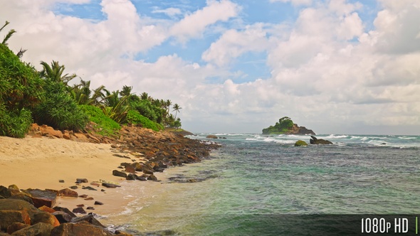 Empty tropical beach coast with partly cloudy skies in slow motion, Sri Lanka alt