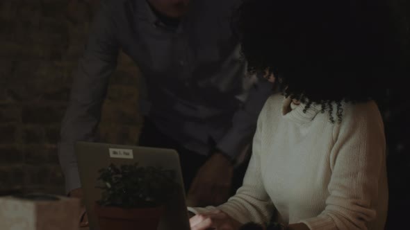 Hipster working late at night in creative office