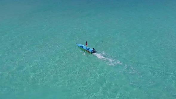 Aerial drone texture of shore beach by blue lagoon with sand background alt
