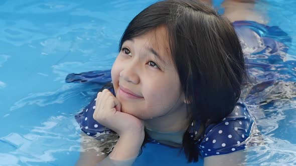 Cute Asian Girl Swimming And Playing In A Pool Slow Motion, Stock Footage