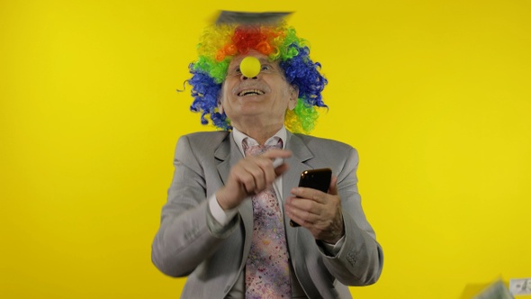 Clown Businessman Freelancer Boss Receives Money Income While Using Smartphone alt