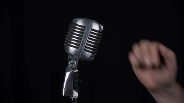 Person speaking into micro phone to see if sound is working alt