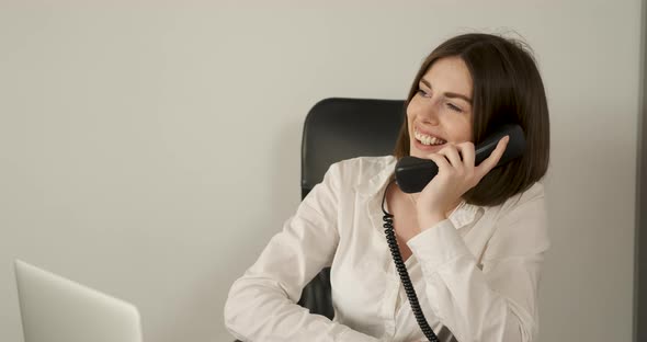Cheerful Female Accountant Working in the Office Woman Making a Business Phone Call