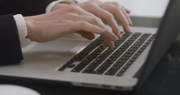 Close Up Shot of an Young Business Woman's Hands Working on Laptop