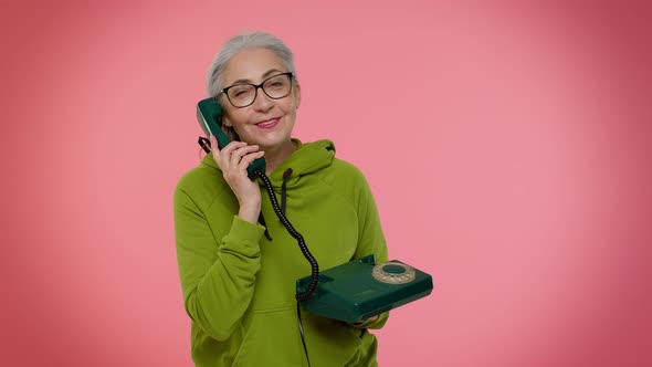 Senior Granny Grayhaired Woman Talking on Wired Vintage Telephone of 80s Says Hey you Call Me Back alt