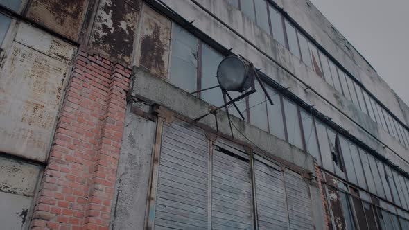 Facade of a Dilapidated Factory Floor with a Fixed Spotlight on the Wall