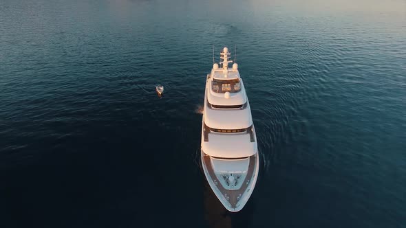 A stunning aerial view of huge luxury yacht and small boat, south of France coast. Super yacht
