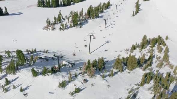 Scenic Snowfall Over Skiers and Snowboarders Riding the Ski Char Lift USA alt